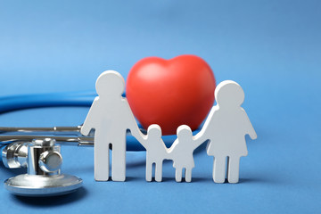 Family figure with stethoscope and heart on color background. Life insurance concept