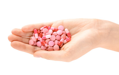 Woman holding color pills on white background, closeup