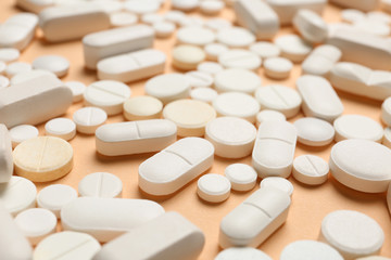 Many different pills on color background