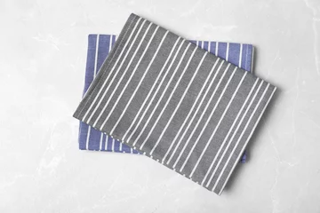 Poster Striped fabric table napkins on light background, top view © New Africa