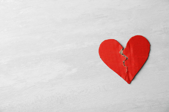 Torn cardboard heart on gray background, top view with space for text. Relationship problems