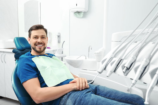 Happy man having dentist's appointment in modern office