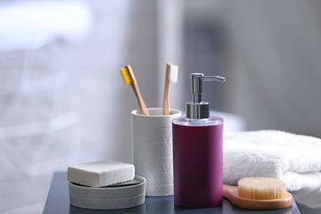 Aromatic soap and toiletries on table against blurred background. Space for text