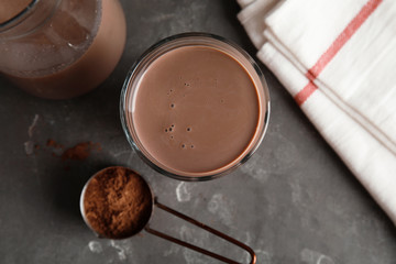 Flat lay composition with glass of tasty chocolate milk on gray background. Dairy drink