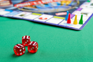several red dice for board games on a green background