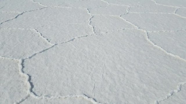Walking through the Uyuni Salar in Bolivia. Close up on the hexagon salt flats. Uyuni, Potosi Bolivia.