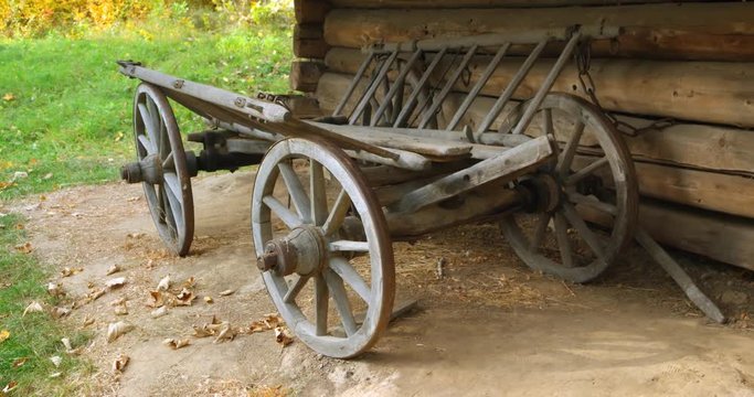Wooden Horse Cart Parked by Log Cabin in Rural Ukraine