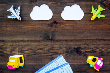 Obraz premium accessories for treveling with children, tickets and toys on wooden background top view mock-up