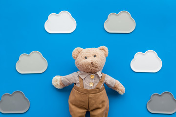 Craft toys for kids. Handmade teddy bear. Blue background top view