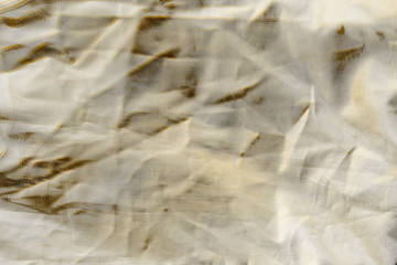 Luxury gold textile background. Silk cloth texture. Fabric pattern.