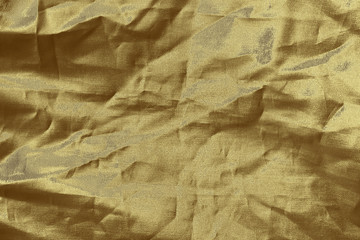 Luxury gold textile background. Silk cloth texture. Fabric pattern.