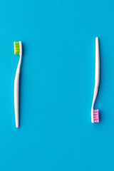 Tooth care with toothbrush. Set of cleaning products for teeth on blue background top view mockup
