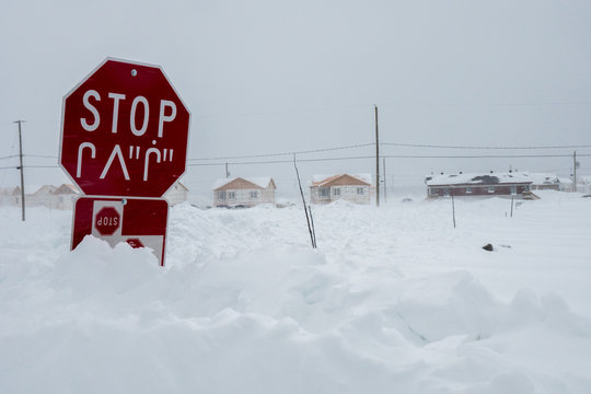 Cree stop sign in two languages in the northern community of Chisasibi, Quebec, winter.