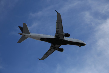airplane in the blu sky close up