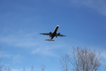 airplane in the blu sky with space for text