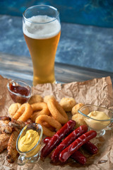 Grilled sausages with glass of beer pic