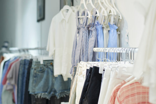 Racks with various clothes in fashion boutique