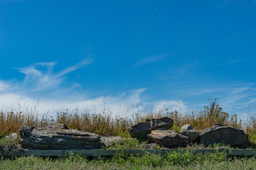 rocks and grass with sky and clouds