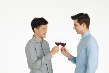 two men clinking glasses pose