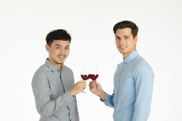 two men clinking glasses pose