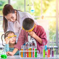 Science teacher teach students in laboratory room..