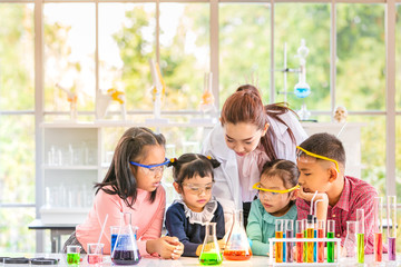 Science teacher teach students in laboratory room..