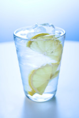 Glass of ice water with lemon 