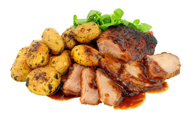 Roast duck meal with roasted potatoes and plumb sauce isolated on a white background