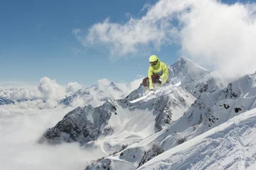 Foto op Canvas Flying skier on snowy mountains. Extreme winter sport, alpine ski. Copy space. © Vasily Merkushev