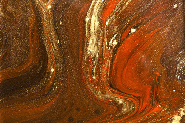 Gold marbling texture design. Red and golden marble pattern. Fluid art.