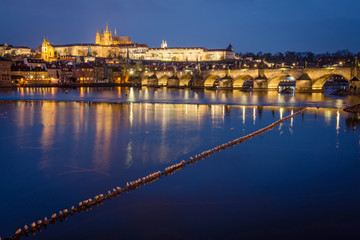Fototapeta na wymiar Prague Castle and Charles Bridge at sunset with reflection on Vltava river, Czech republic