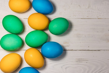 Fototapeta na wymiar Painted Easter eggs on white wooden background