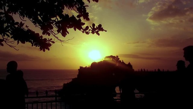 Silhouette Of Walking People On Sunset Beach View Batu Bolong At Tanah Lot, Tabanan, Bali, Indonesia