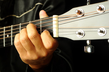 Guitarist plays the guitar. Close-up
