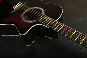 Acoustic black guitar. Close-up