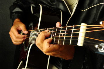 Fototapeta na wymiar Guitarist plays the guitar. Close-up