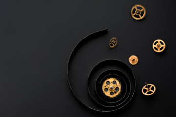 Gears on a black background.Broken mechanism.Spring from wall clock