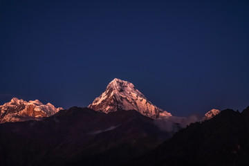Snow Peak of Annapurna Mountain Glowing at Moonlight at Night in the Himalayas in Nepal