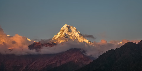 Snow Peak of Annapurna Mountain at Sunrise among Clouds in the Himalayas in Nepal