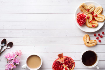 Valentine's day Breakfast concept. Cup of coffee and a cookies hearts on a white table two persons. copy space, flat lay.