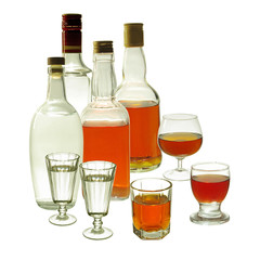 Whiskey and gin in glasses and bottles on a white background. Isolated on white