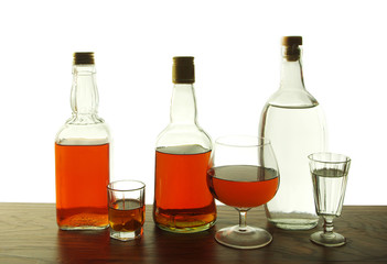 Whiskey and gin in glasses and bottles on a white background. Isolated on white