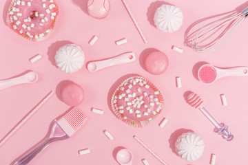 Kitchenware and tools, pastry and sweets on a pink background. Top view.