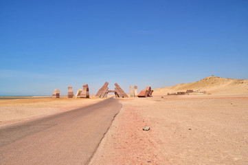 Fototapeta na wymiar The road to the stone gates and columns of sandstone of different colors at the entrance to the national park of Ras Mohammed