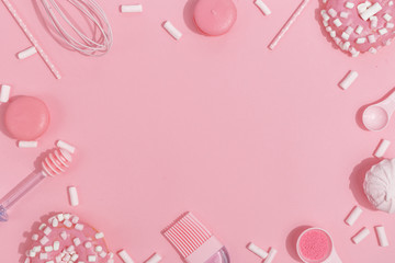 Kitchenware and tools, pastry and sweets on a pink background. Top view. Copy space.