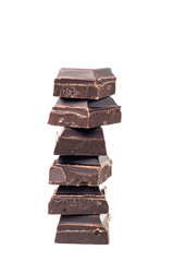 Chopped chocolate cubes, pieces of dark chocolate bar isolated on white background