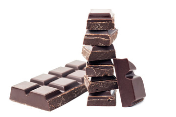 Chopped chocolate cubes, pieces of dark chocolate bar isolated on white background