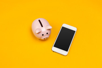 Piggy bank with mobile phone.