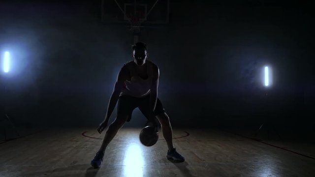 Sportsman playing basketball in basketball court