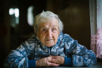 Elderly russian woman portrait in the his home.